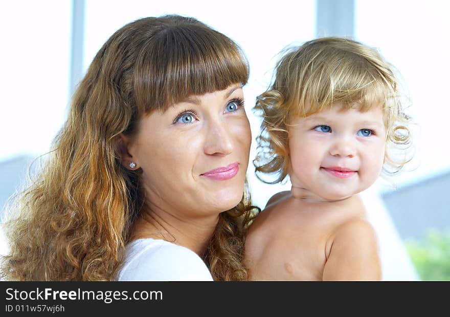 High key portrait of happy mother with baby. High key portrait of happy mother with baby