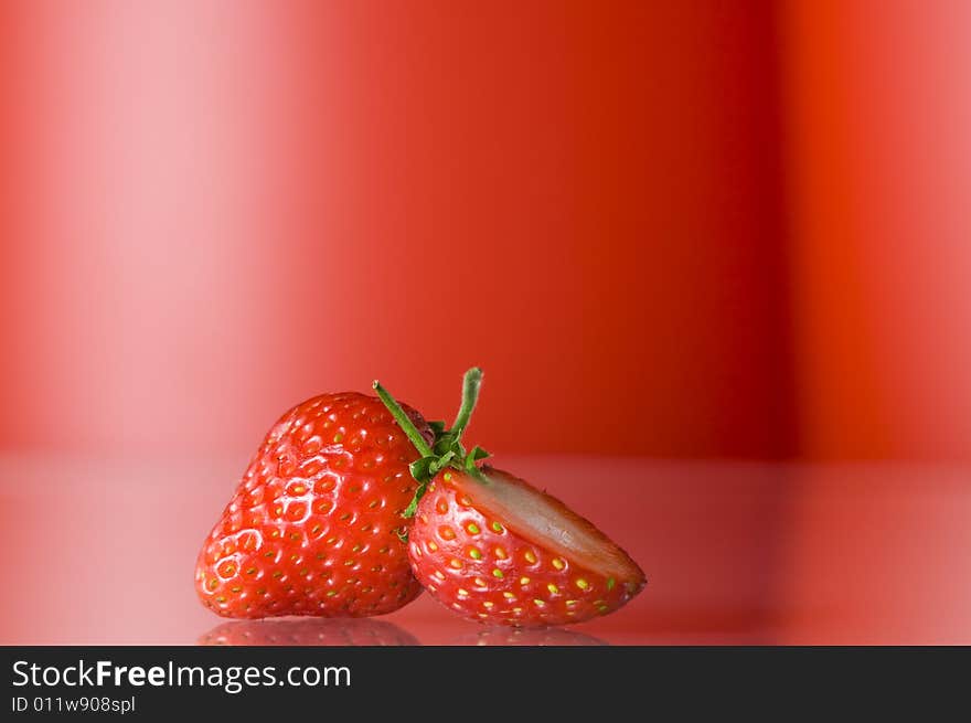 Close up view of nice fresh red berry on red back. Close up view of nice fresh red berry on red back