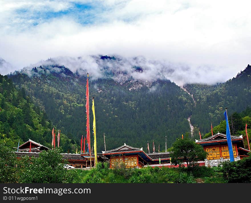 Tibetan village with mountian and clouds in background,Sichuan,china