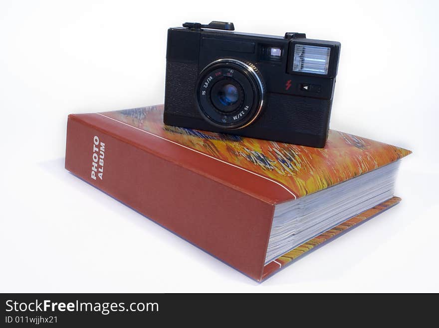 Film camera and photo album isolated on a white background