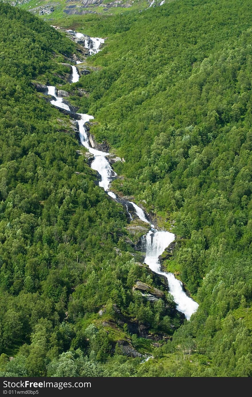 Narrow creek running in a lush narrow valley. Narrow creek running in a lush narrow valley