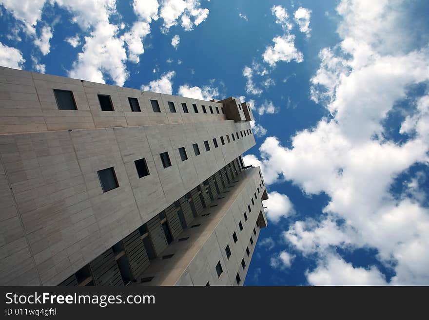 Skyscraper on a blue sky with white clouds