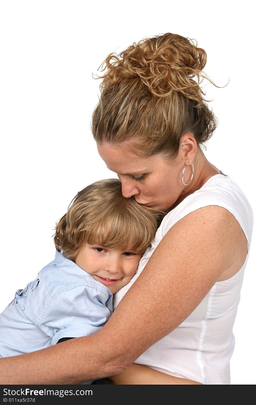 Mother holding son and kissing his head. Mother holding son and kissing his head