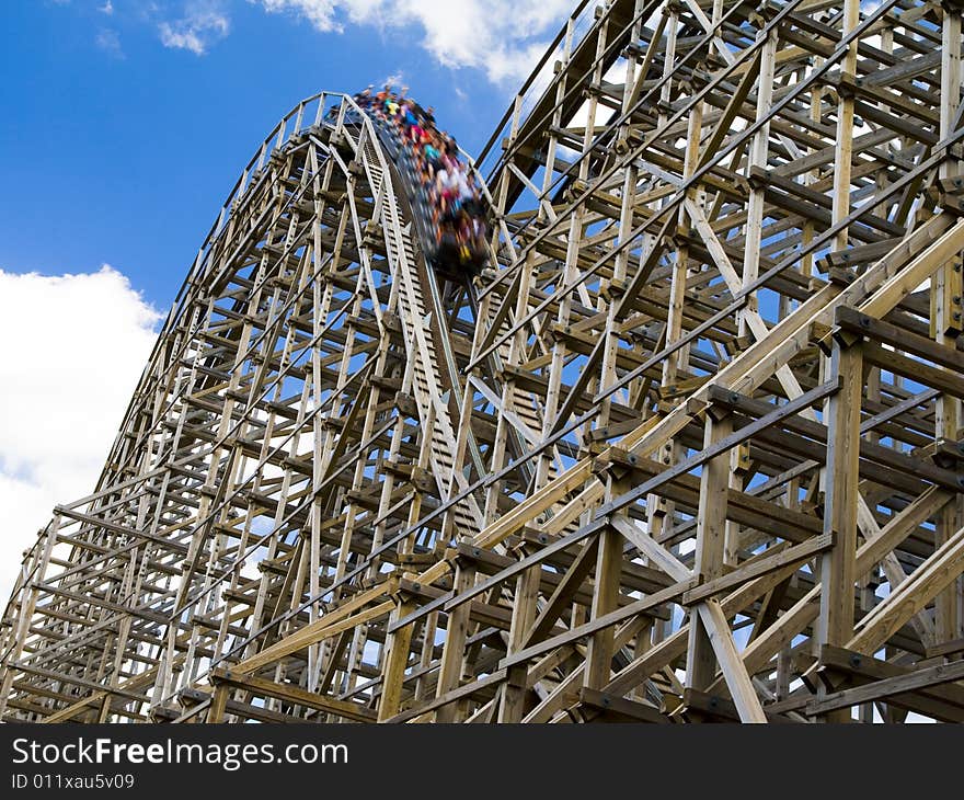 Photo of a wooden roller coaster in a theme park in the USA