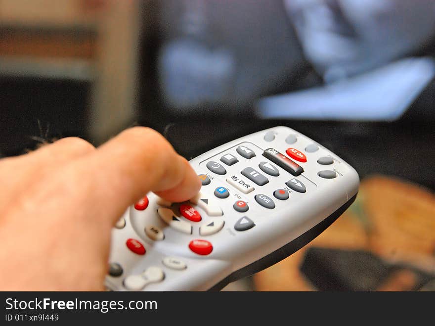 Candid of hand holding remote changing channels. Candid of hand holding remote changing channels