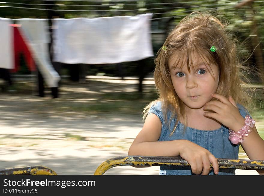 Little girl on the blured drying linen background. Little girl on the blured drying linen background