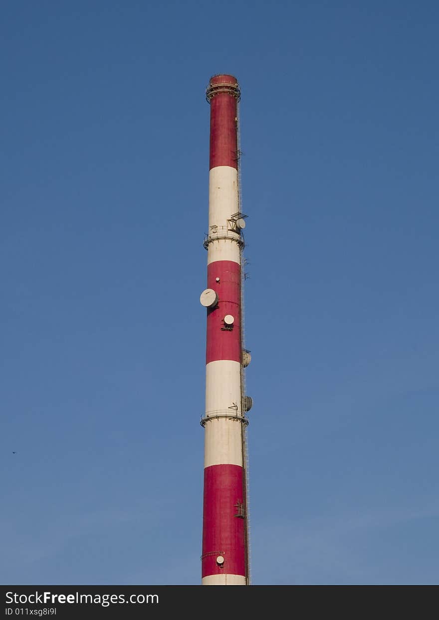 Tall chimney on a blue sky