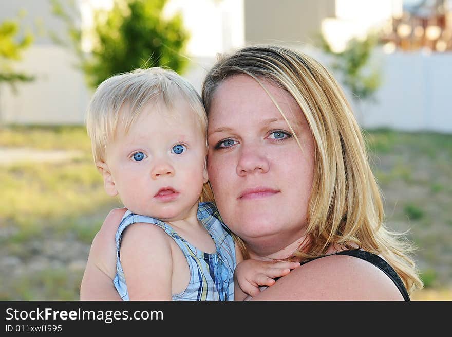 Mother holding her son towards the camera. Mother holding her son towards the camera