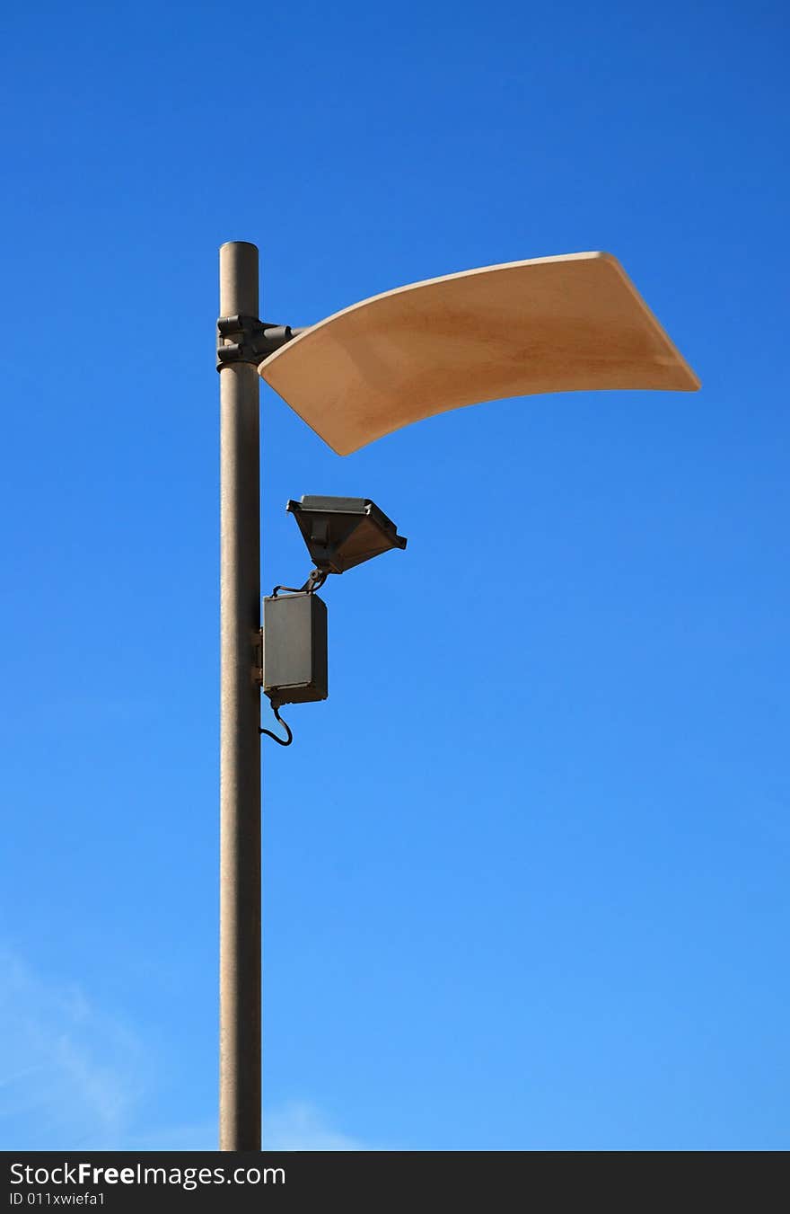 Modern lamppost against blue sky