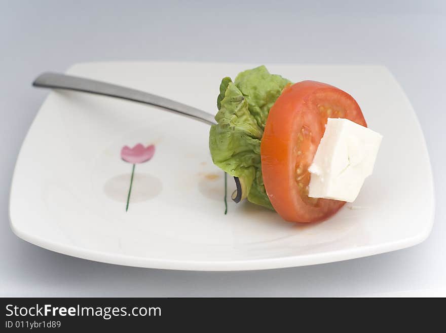 Lettuce, cheese, tomato, zucchini isolated on white background