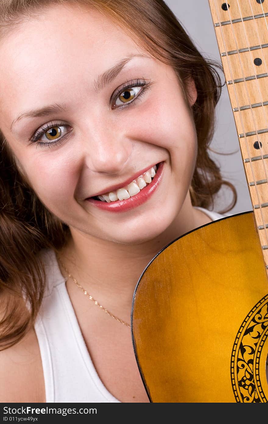 Close-up portrait of beautiful girl posing with guitar. #1