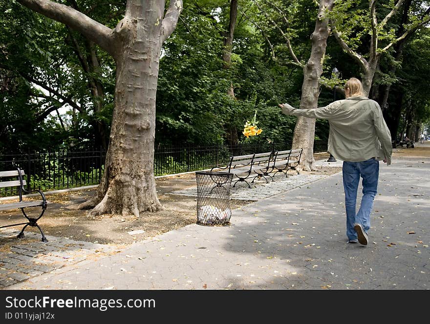 Adolescent Male Throwing Flowers Into Trash Can.2