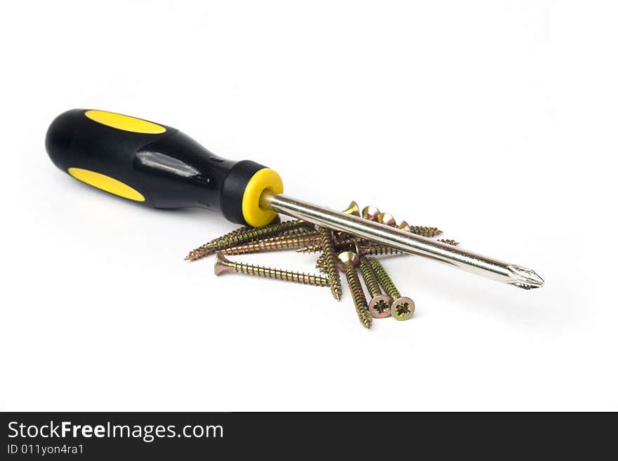 Yellow and black handled phillips screwdriver with pile of screws on white background. Yellow and black handled phillips screwdriver with pile of screws on white background