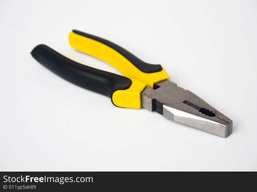 Yellow and black handled blunt nosed pliers on white background