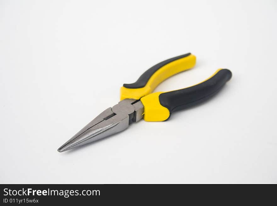 Yellow and black handled needle nose pliers against a white background