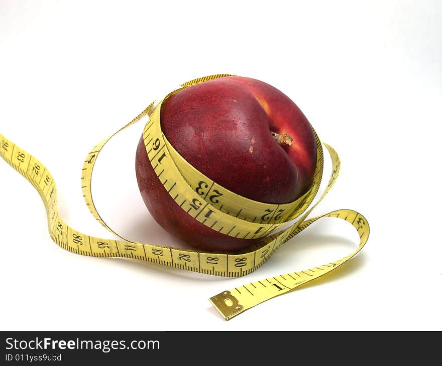 Fruit and measuring tape isolated on white. Fruit and measuring tape isolated on white