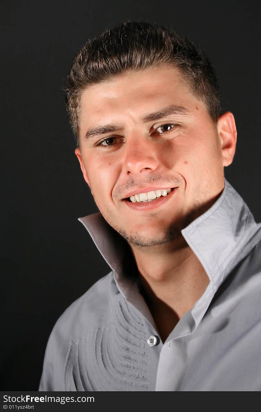 Male model in studio against black background