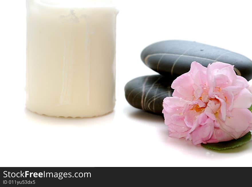 Spa stones with candle and flower