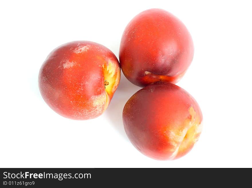 Three fruit nectarines. On a white background.