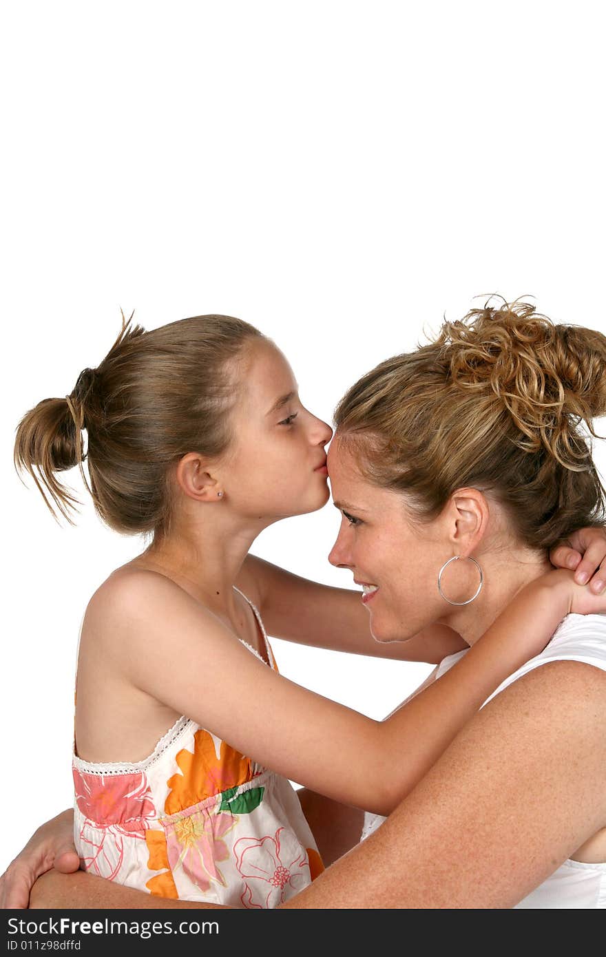 Daughter kissing mother on forehead