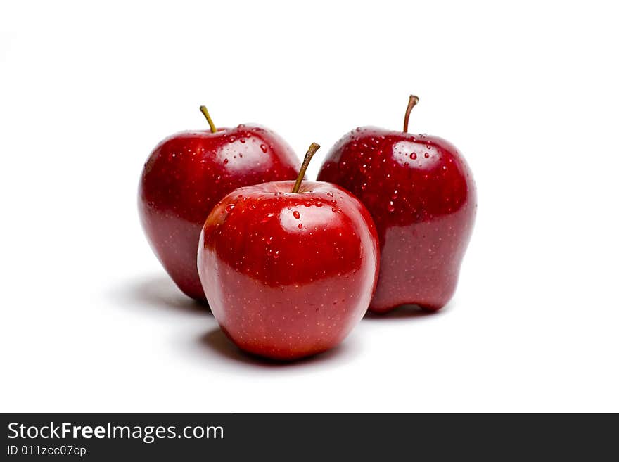 Three Red Apples on White Glis