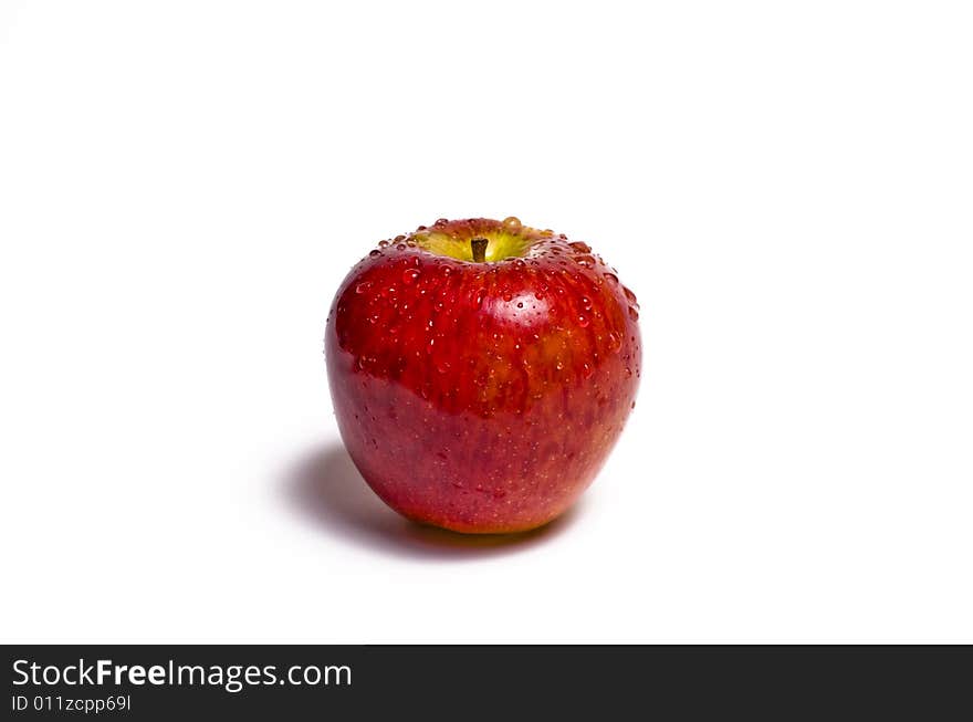 Red apple glistening with water isolated on white. Red apple glistening with water isolated on white