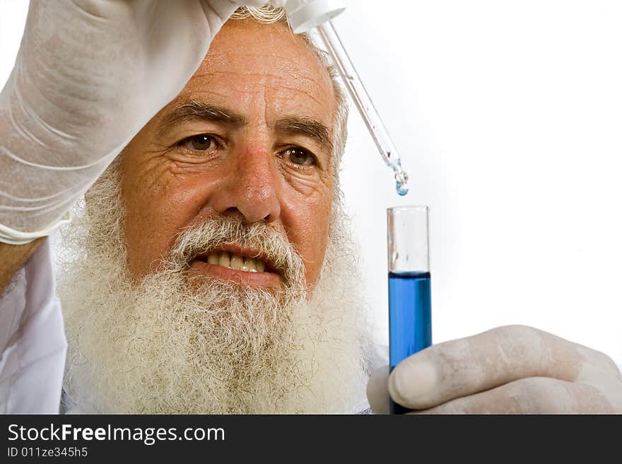 Mature scientist in laboratory holding pipette and test tube with blue liquid isolated on white