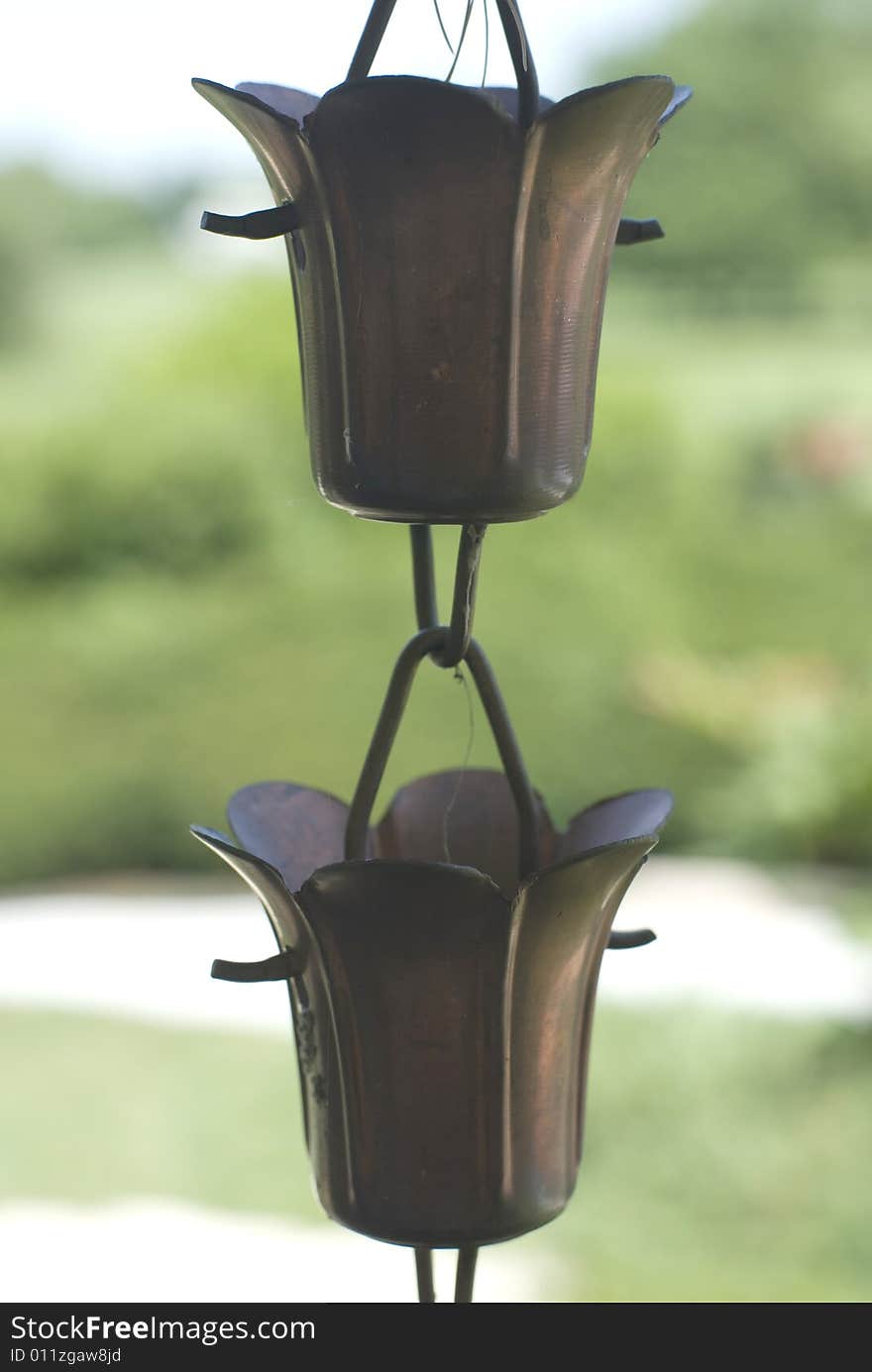 Two bronze hanging vases shaped like tulips. Two bronze hanging vases shaped like tulips.