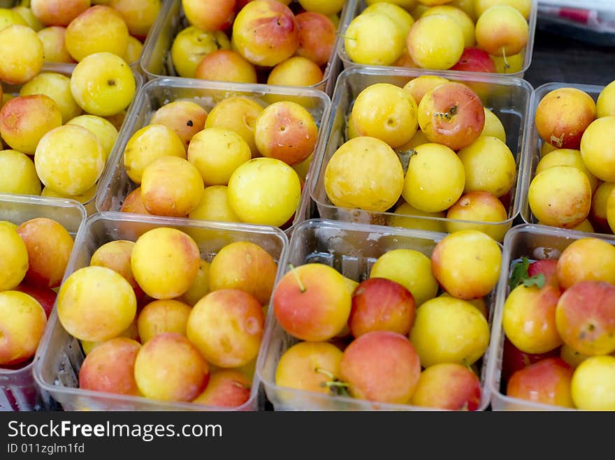 Close up shot of yellow and red Rainier cherries in clear plastic containers. Close up shot of yellow and red Rainier cherries in clear plastic containers.