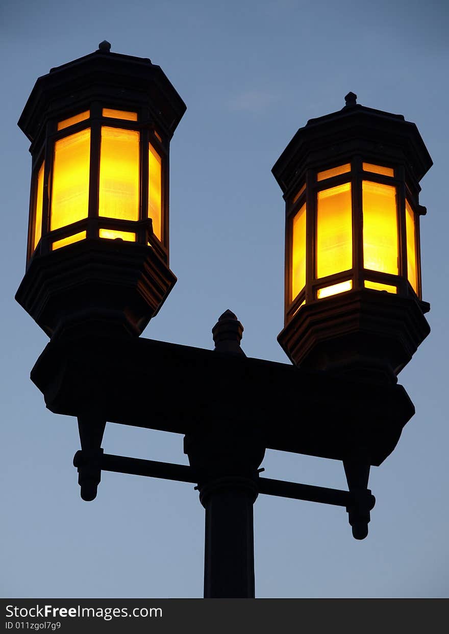 Dual Yellow Lamp Streetlight against blue sky. Dual Yellow Lamp Streetlight against blue sky