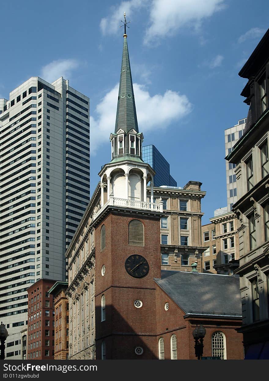 Historic Brick Church and Modern Buildings blue sky