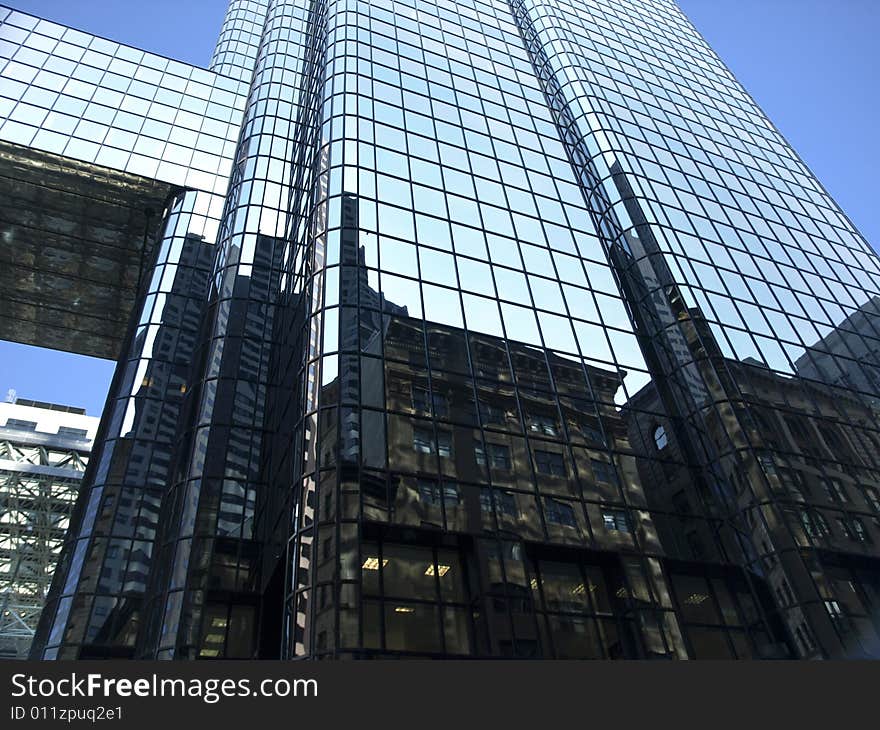 Glass Towering Skyscraper Perspective against blue sky. Glass Towering Skyscraper Perspective against blue sky