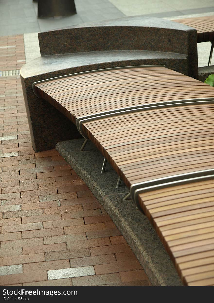 Modern Design Wooden Slat Sitting Bench on bricks. Modern Design Wooden Slat Sitting Bench on bricks