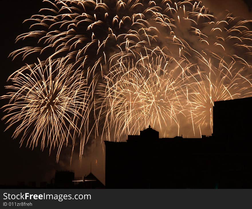 Colorful Fireworks burst display with building silhouette. Colorful Fireworks burst display with building silhouette