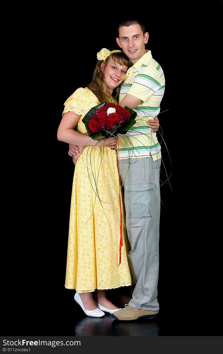 Young happy laughing wedding couple on black background, studio shot. Young happy laughing wedding couple on black background, studio shot