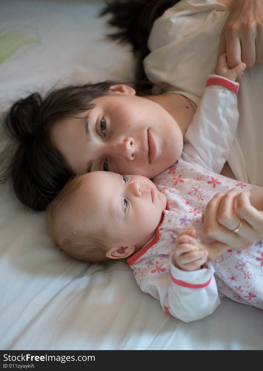 Baby with mom in the bed