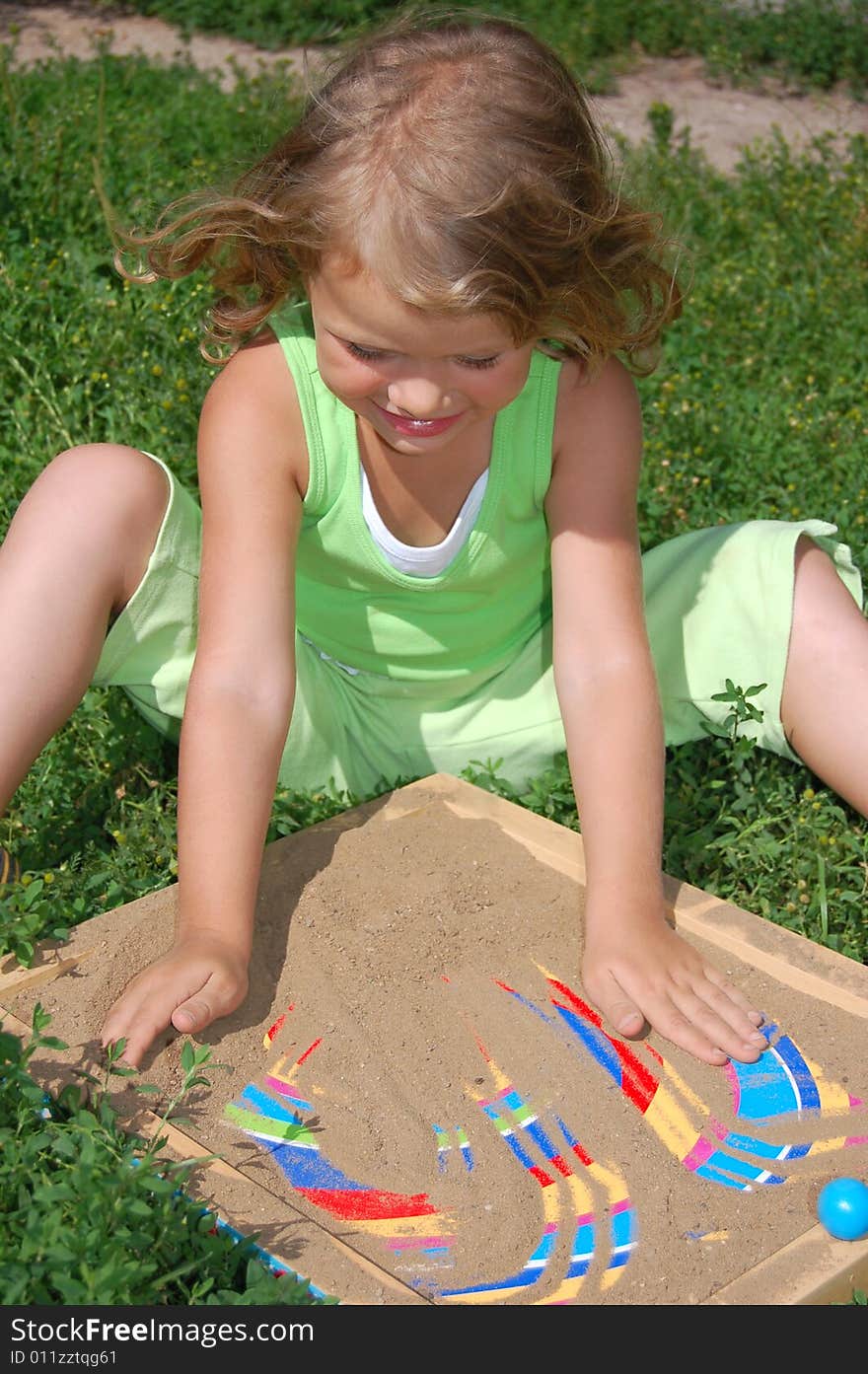 Pretty girl playing with sand