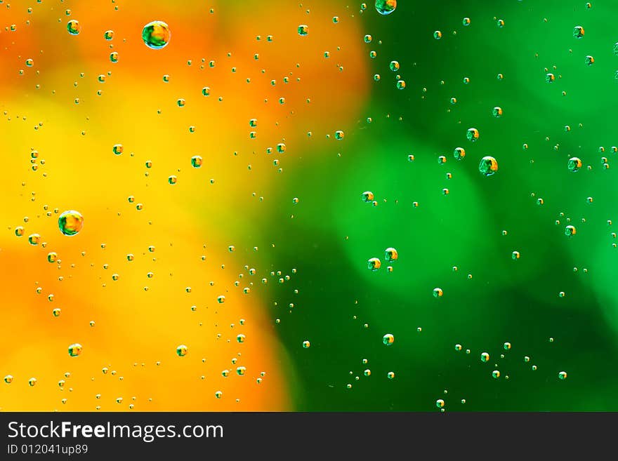 Drops of water on a green, yellow background. Drops of water on a green, yellow background.