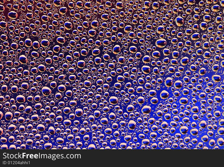 Drops of water on a blue, lila background. Drops of water on a blue, lila background.