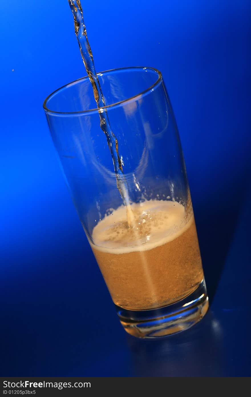 Glass of beer on a blue background. Glass of beer on a blue background.