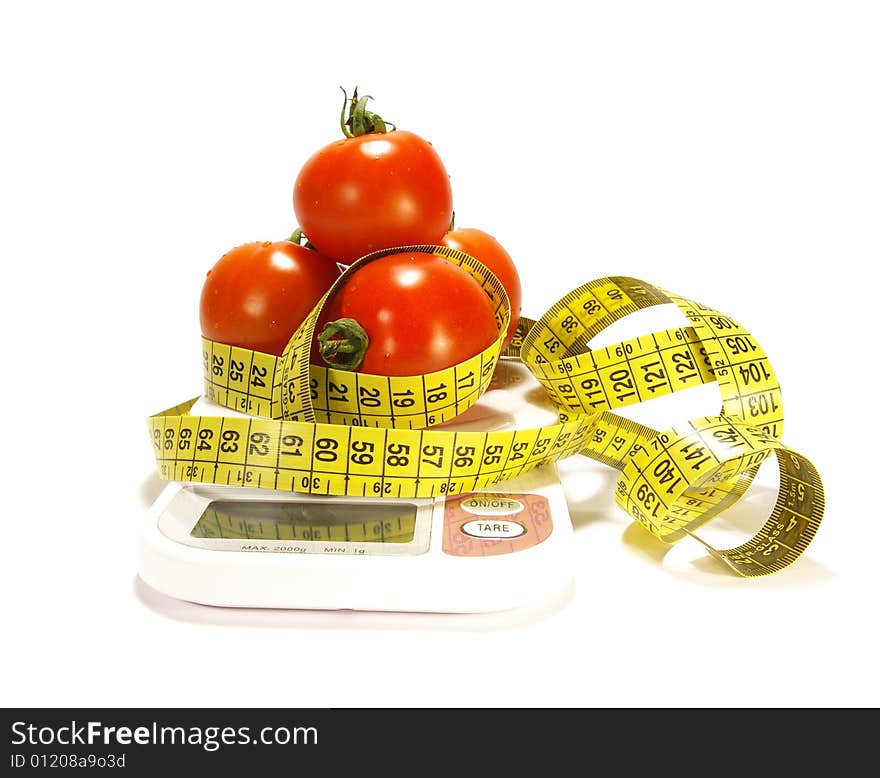 Ripe juicy tomato and tape measure isolated