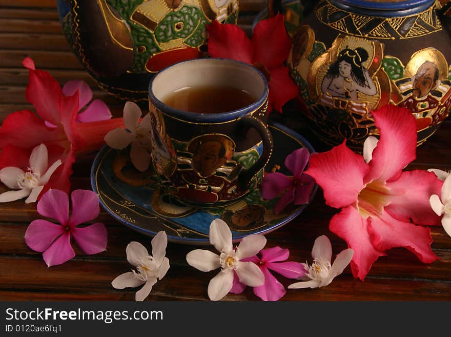 Tea set with tea and flowers