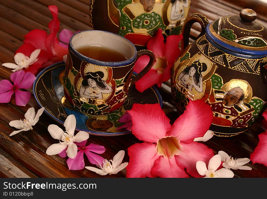 Tea set with tea and flowers