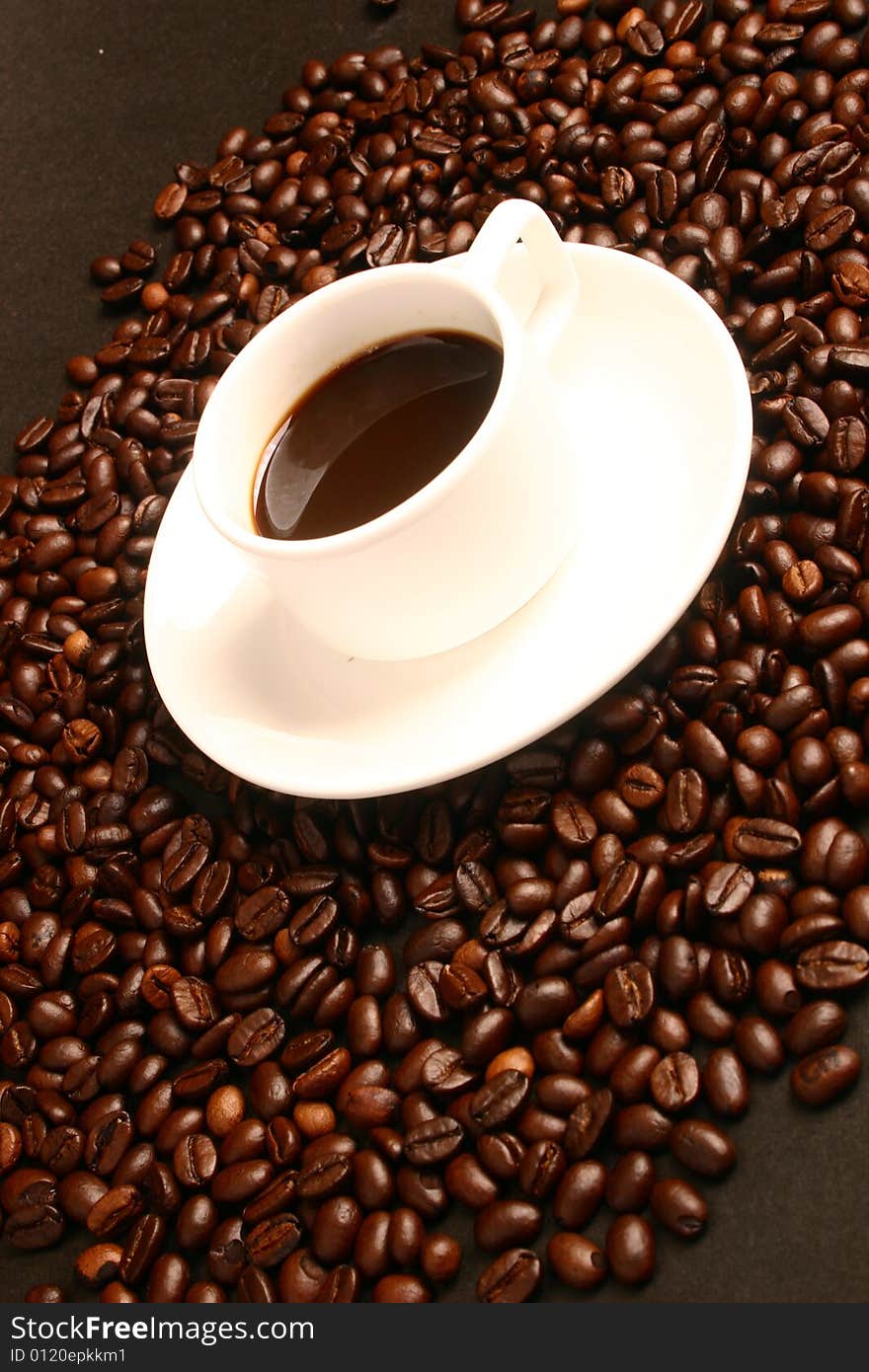 A cup of coffee with a coffee beans. A cup of coffee with a coffee beans