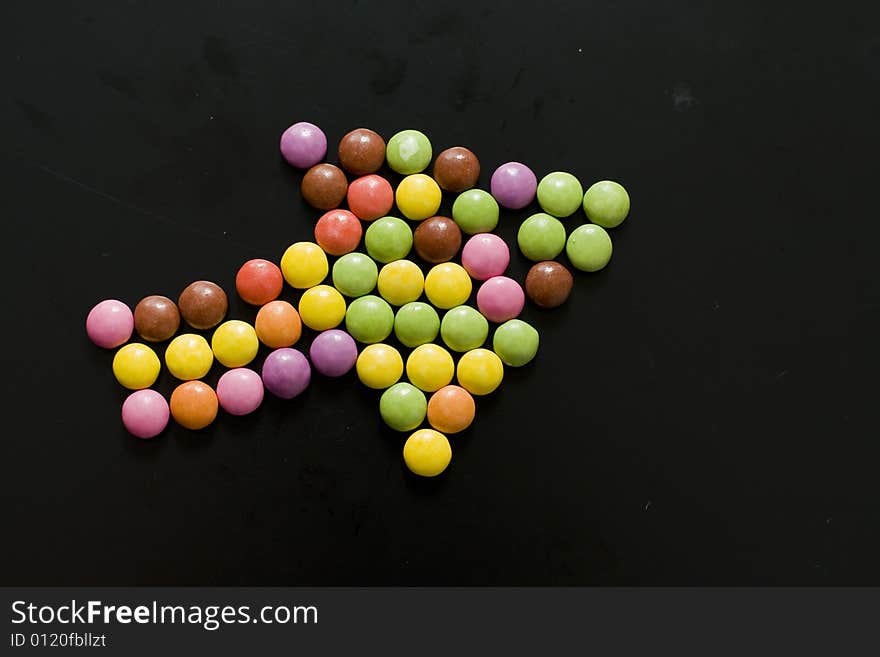 Huge arrow composed from pills of different colors. Huge arrow composed from pills of different colors