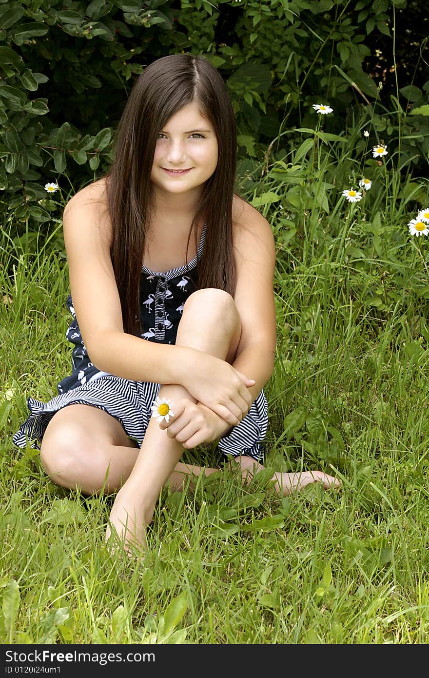 Beautiful brunette girl sitting in the park. Beautiful brunette girl sitting in the park