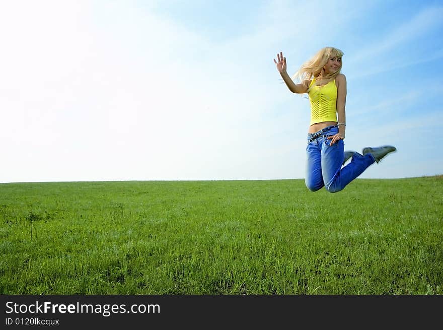 Happy beauty young woman jump in field