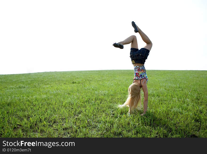 Happy beauty young woman jump in field