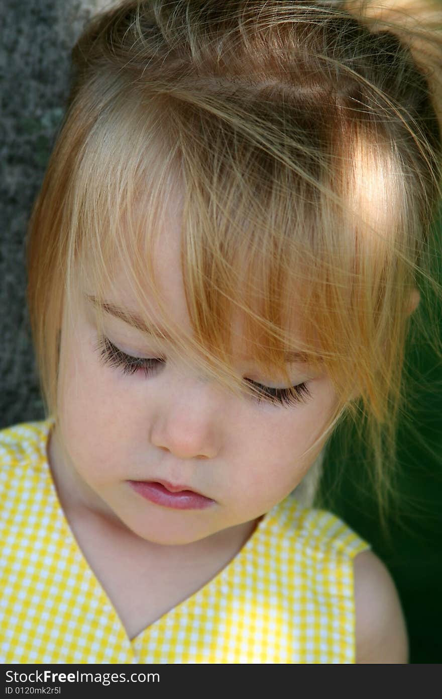 Little girl with downcast eyes. Little girl with downcast eyes