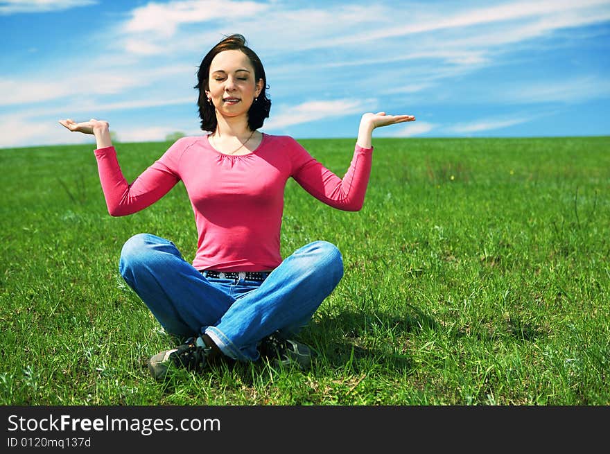 Woman in field hold hand palm up under blue sky and clouds